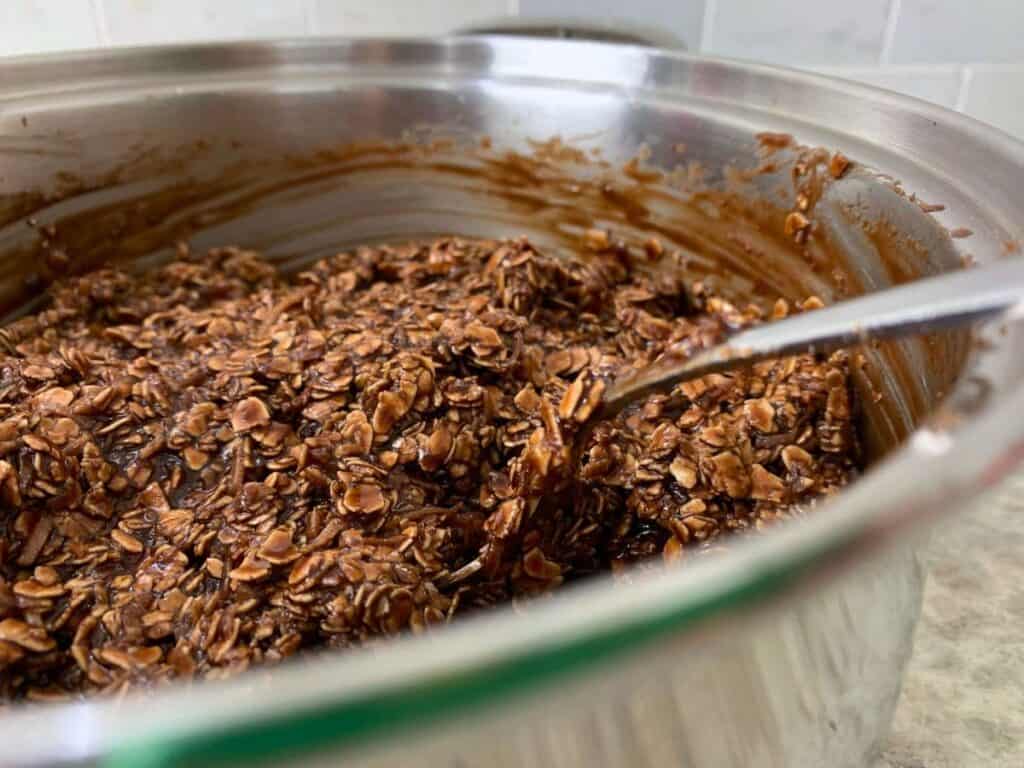 a mixture of coconut, oats, cocoa powder, sugar, milk, butter in a saucepan