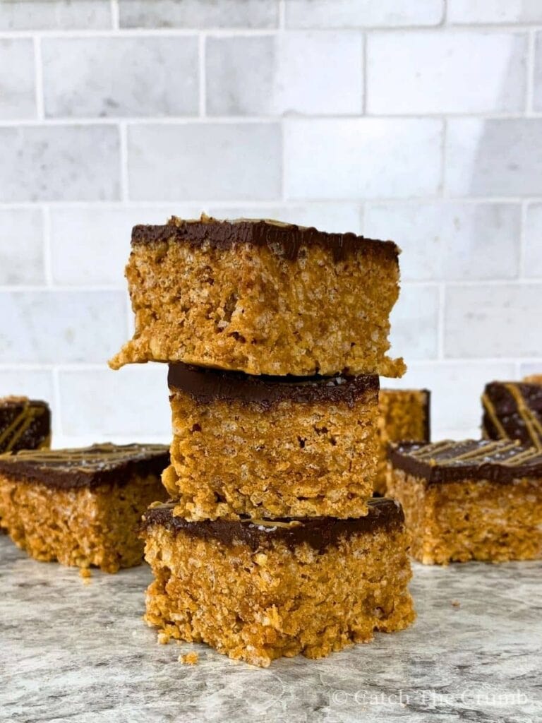 3 peanut butter and chocolate rice krispies bars stacked ontop of one another