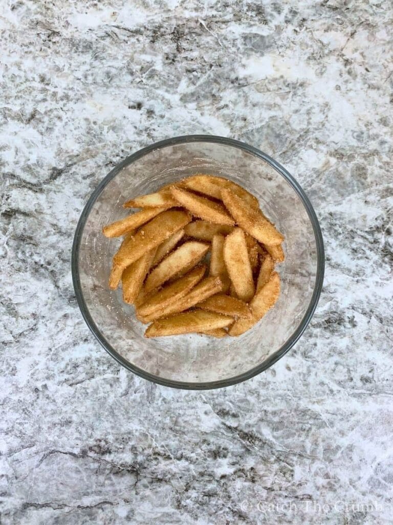 apple slices tossed in the mixture of granulated sugar, cinnamon, and flour
