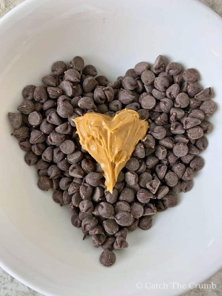 chocolate chips and peanut butter in the shape of two hearts