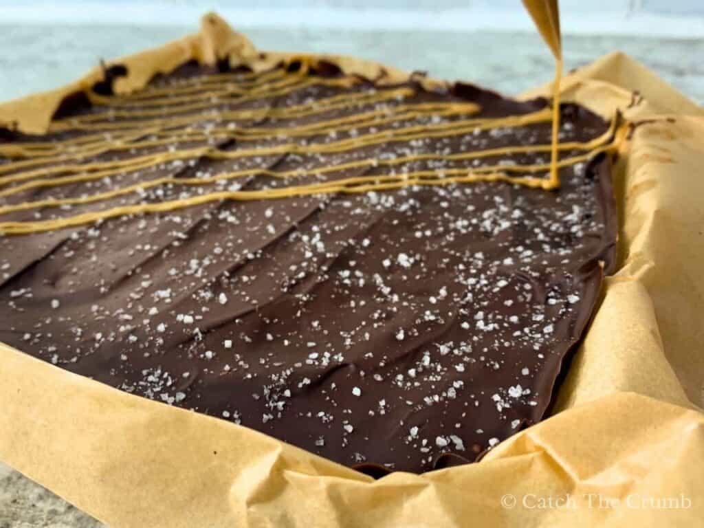 piping peanut butter onto the solidified chocolate