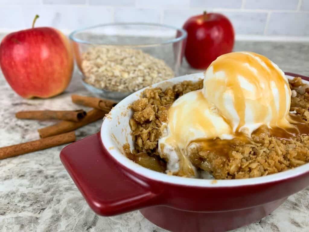 single serve apple crisp with vanilla ice cream and caramel sauce