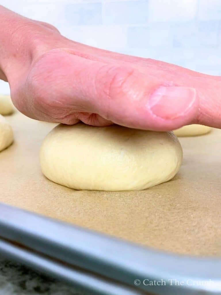 Flattening the buns slightly