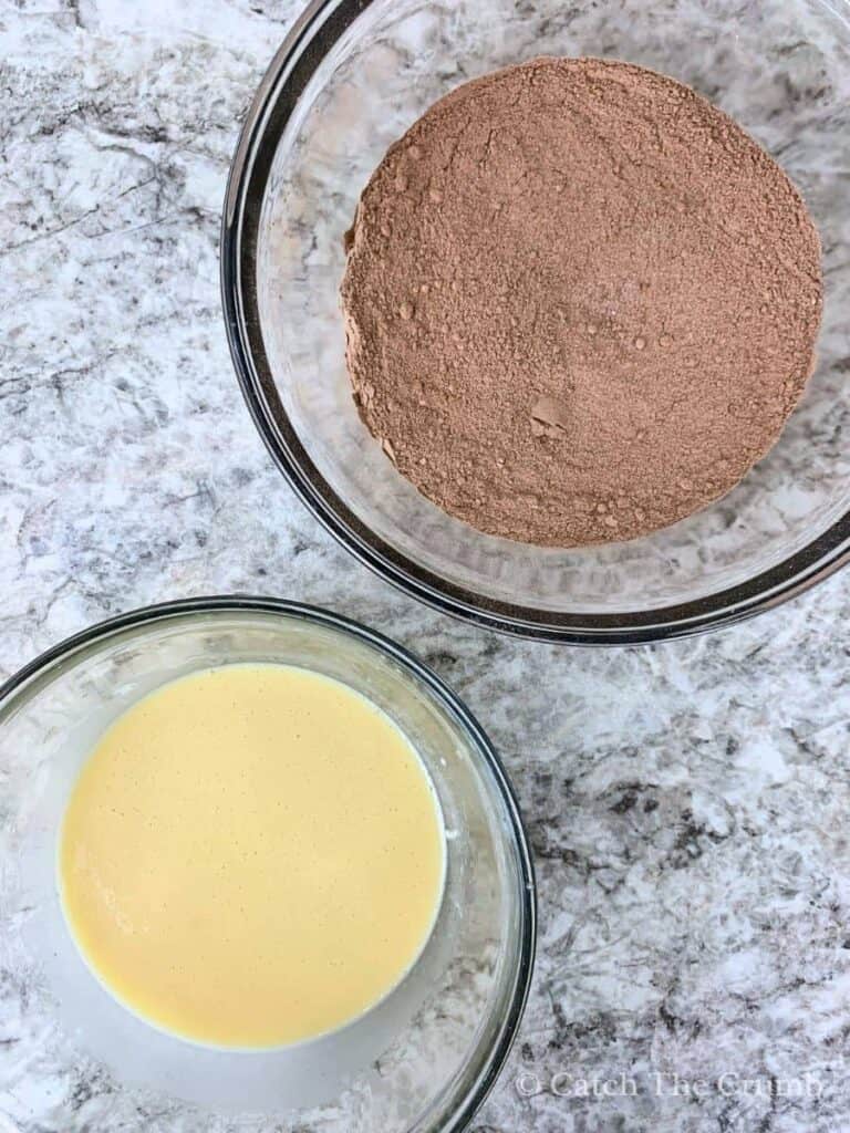 a mixing bowl containing the dry ingredients next to a mixing bowl containing the wet ingredients