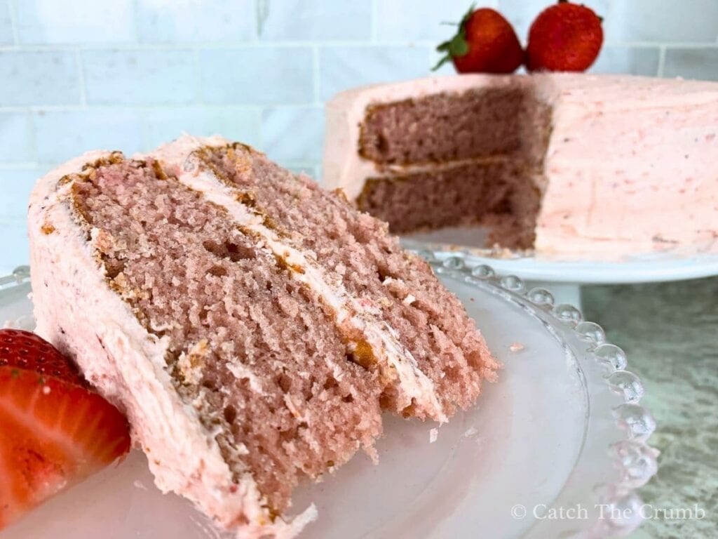 a slice of sourdough strawberry cake cut out and removed from the cake