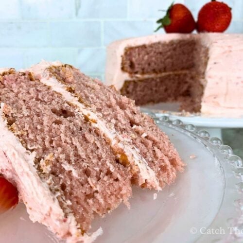 a slice of sourdough strawberry cake cut out and removed from the cake