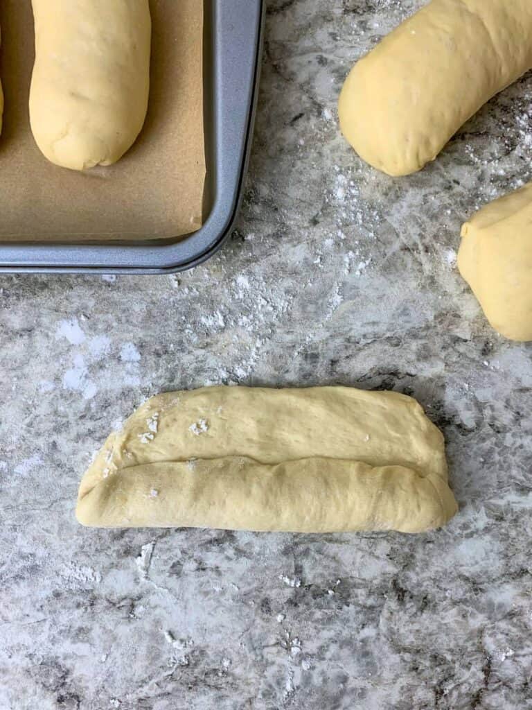 rolling the dough up tightly into a log