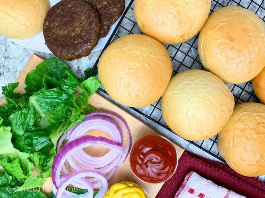 sourdough discard hamburger buns served with burgers and toppings
