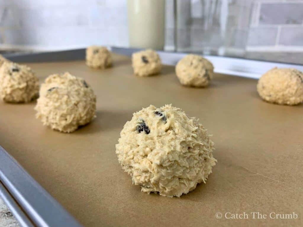 sourdough discard oatmeal chocolate chip cookie dough balls on a baking sheet