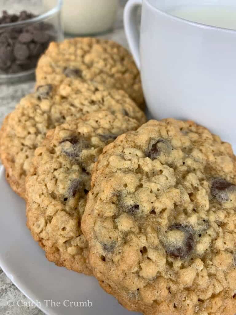 sourdough discard oatmeal chocolate chip cookies on a plate with a glass of milk