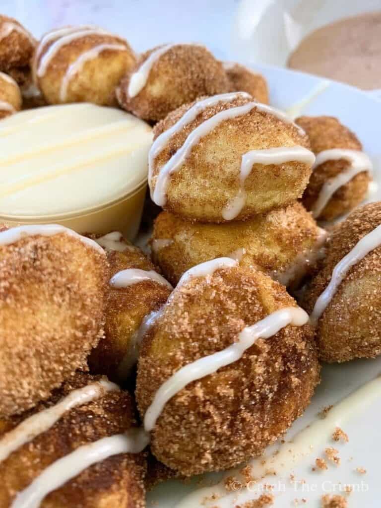sourdough discard pretzel bites tossed in cinnamon sugar and drizzled with sweet icing glaze