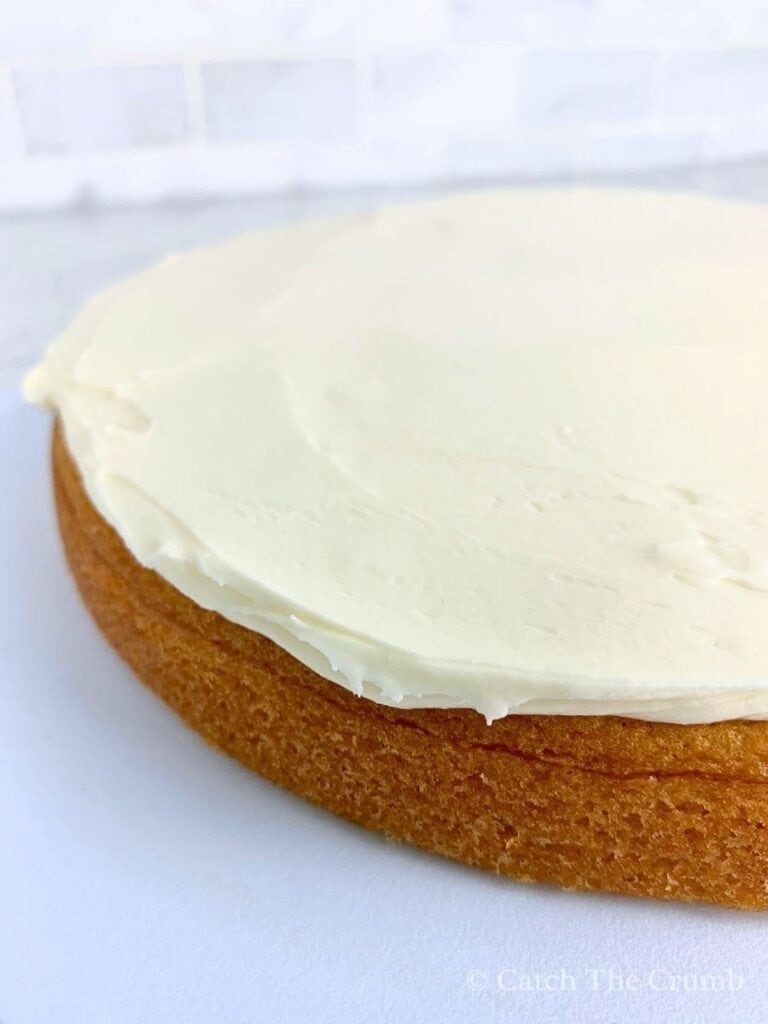 1 cup of buttercream spread evenly on the first layer of the sourdough vanilla cake