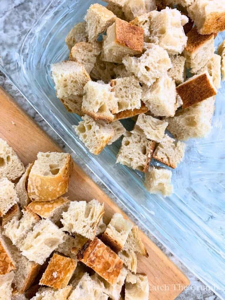 1-inch cubes of sourdough loaf placed in a greased pan