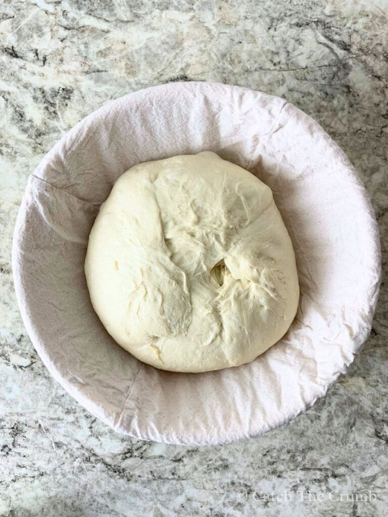 Placing the dough into a floured banneton