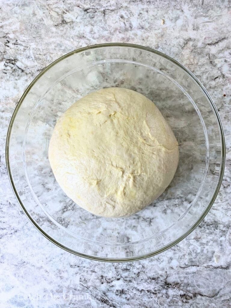 a dough ball placed in a greased bowl
