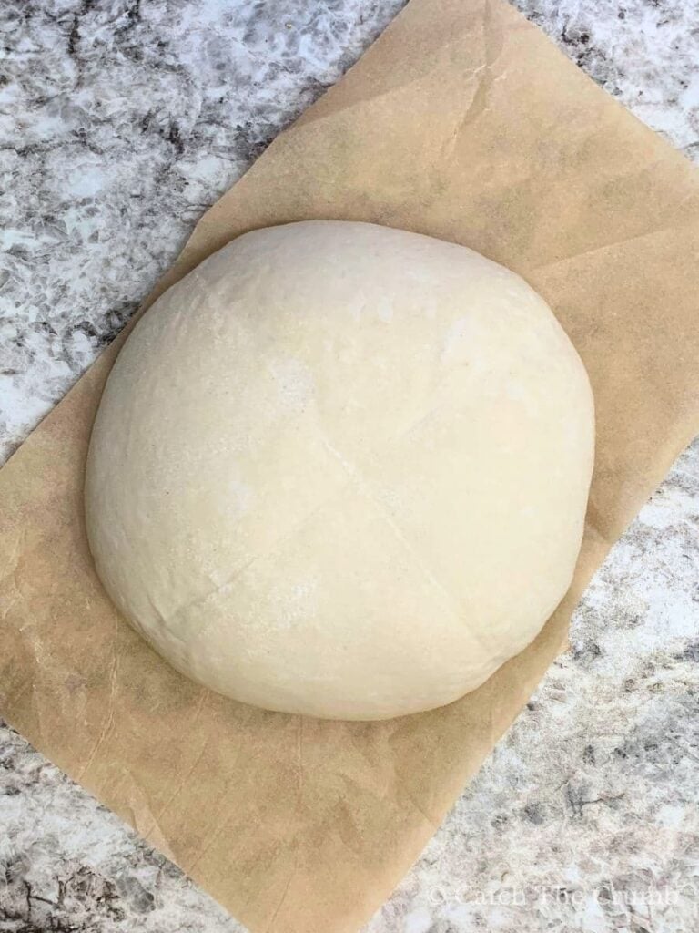 chilled dough laying on a piece of parchment paper