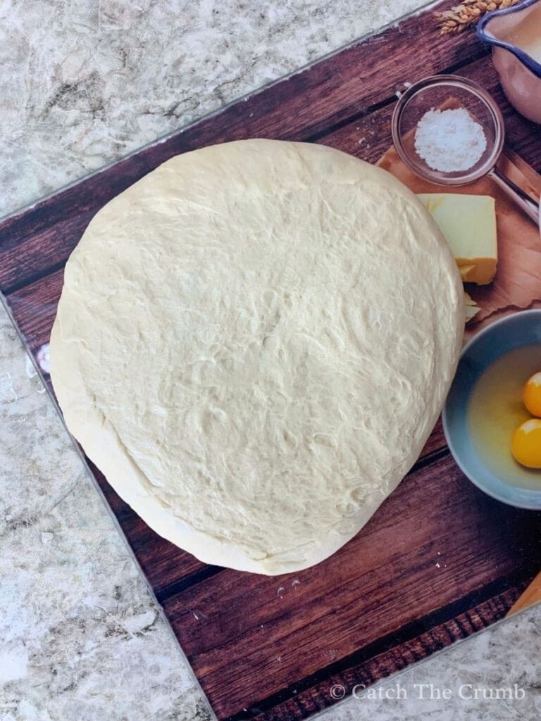 dough flipped over with the smooth side facing down and the sticky side facing up