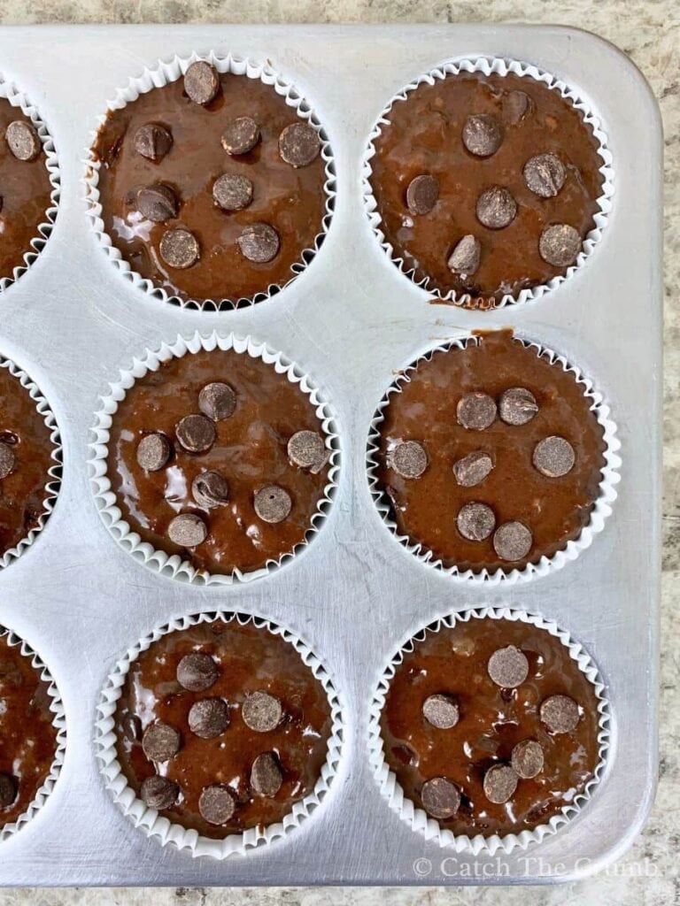 mixture in muffin liners with chocolate chips sprinkled on top