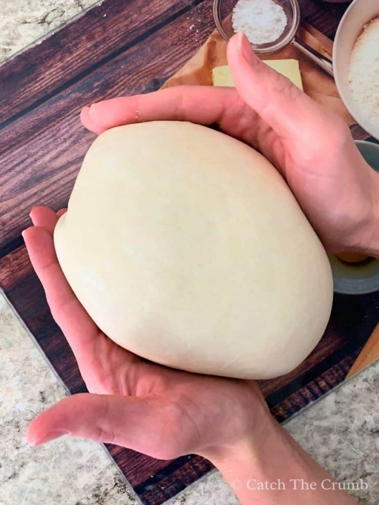 shaping the dough into a rounder ball