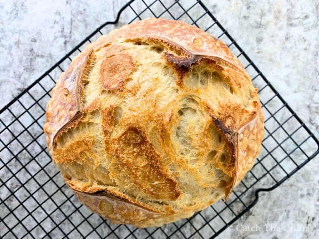 sourdough bread loaf on a wire cooling rack
