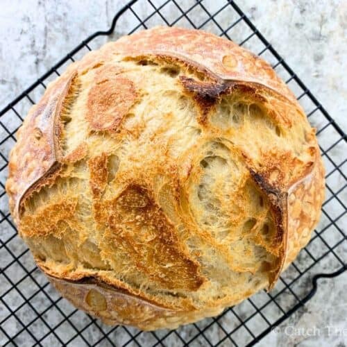 sourdough bread loaf on a wire cooling rack