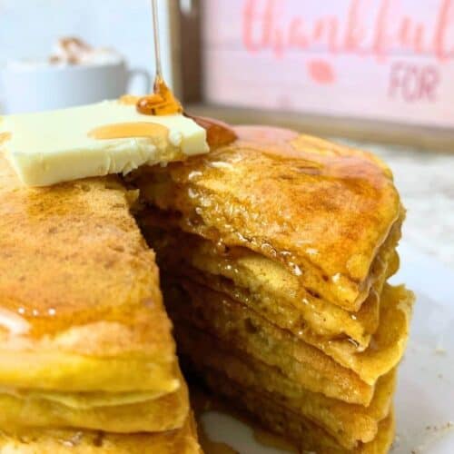 stack of sourdough pumpkin pancakes with butter and maple syrup