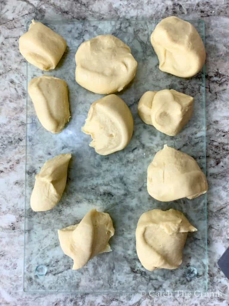 10 dough balls sitting on a cutting board