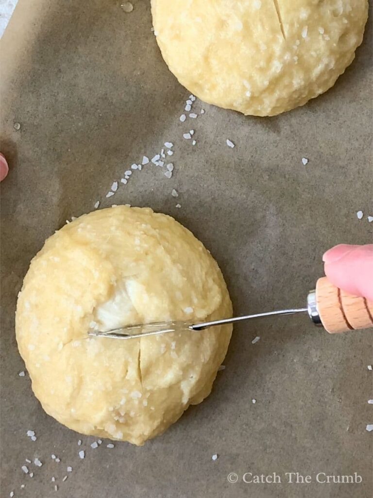 coarse salt sprinkled onto dough ball after baking soda bath