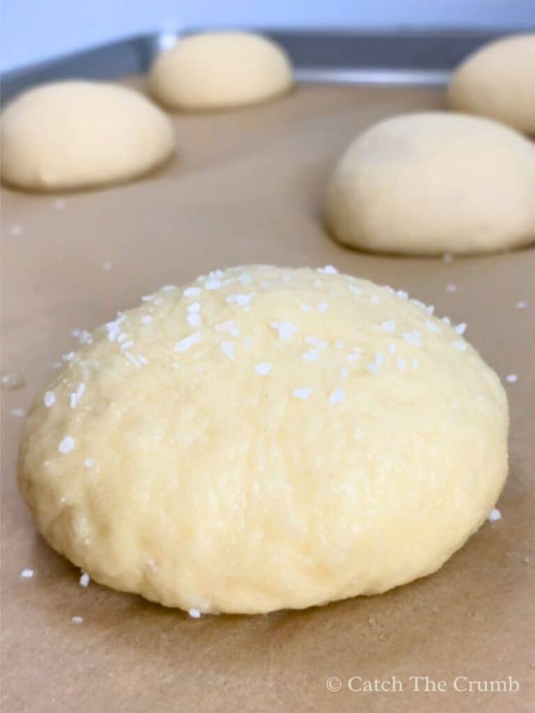 coarse salt sprinkled onto dough ball after baking soda bath