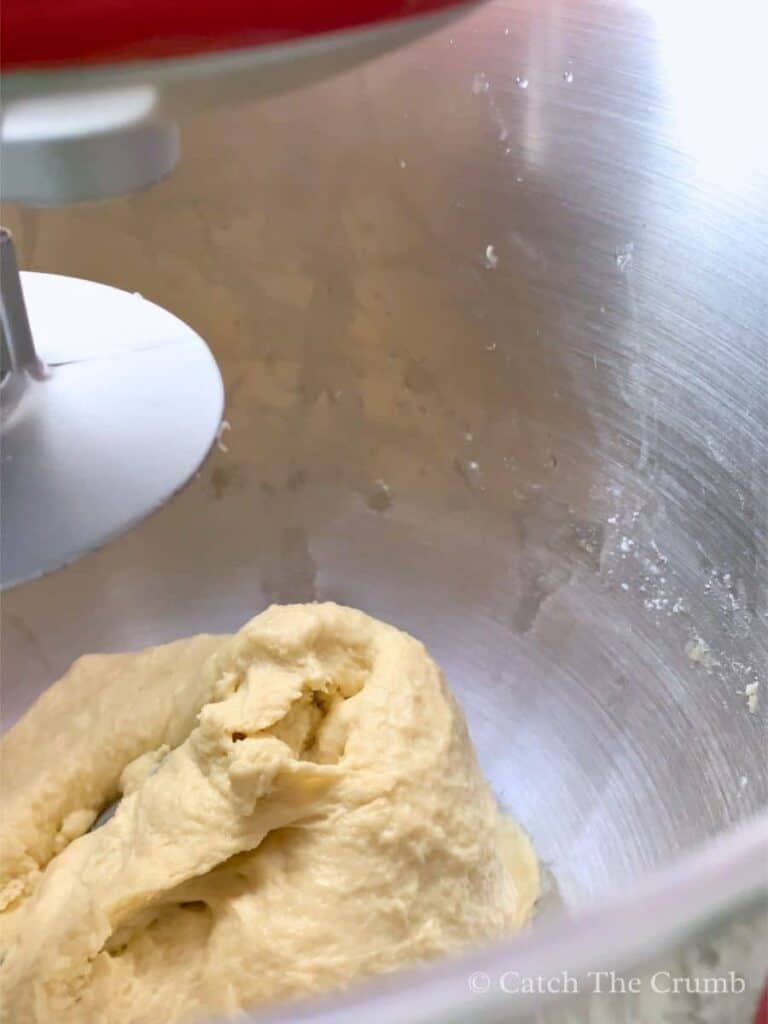 dough ball forming inside mixing bowl