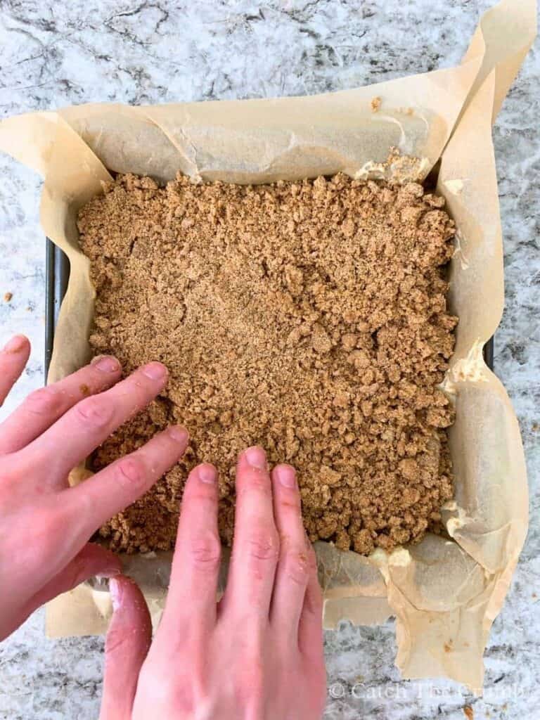 finishing with a layer of crumble on top of the batter layer