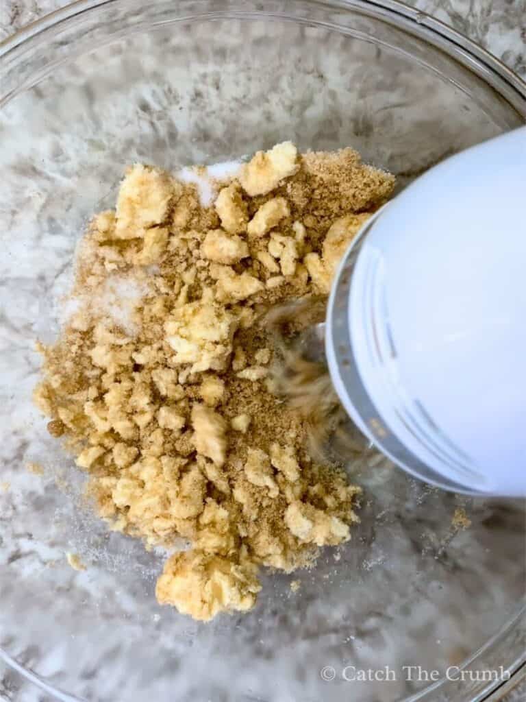 mixing butter and sugar in a mixing bowl with a hand mixer