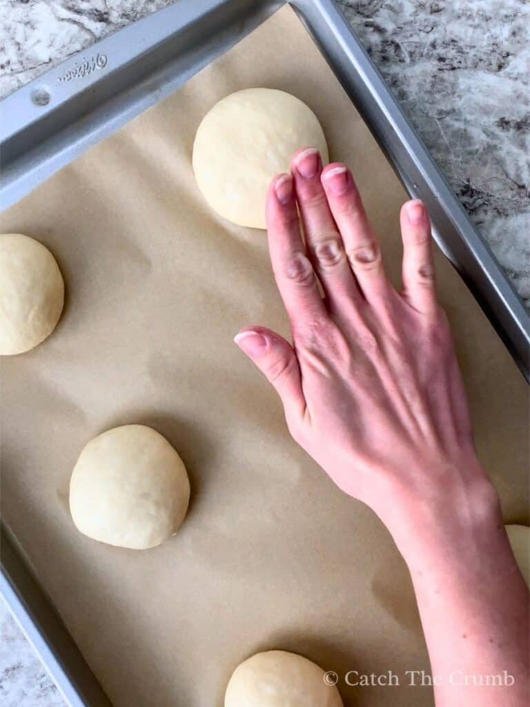 pushing down slightly on each dough ball