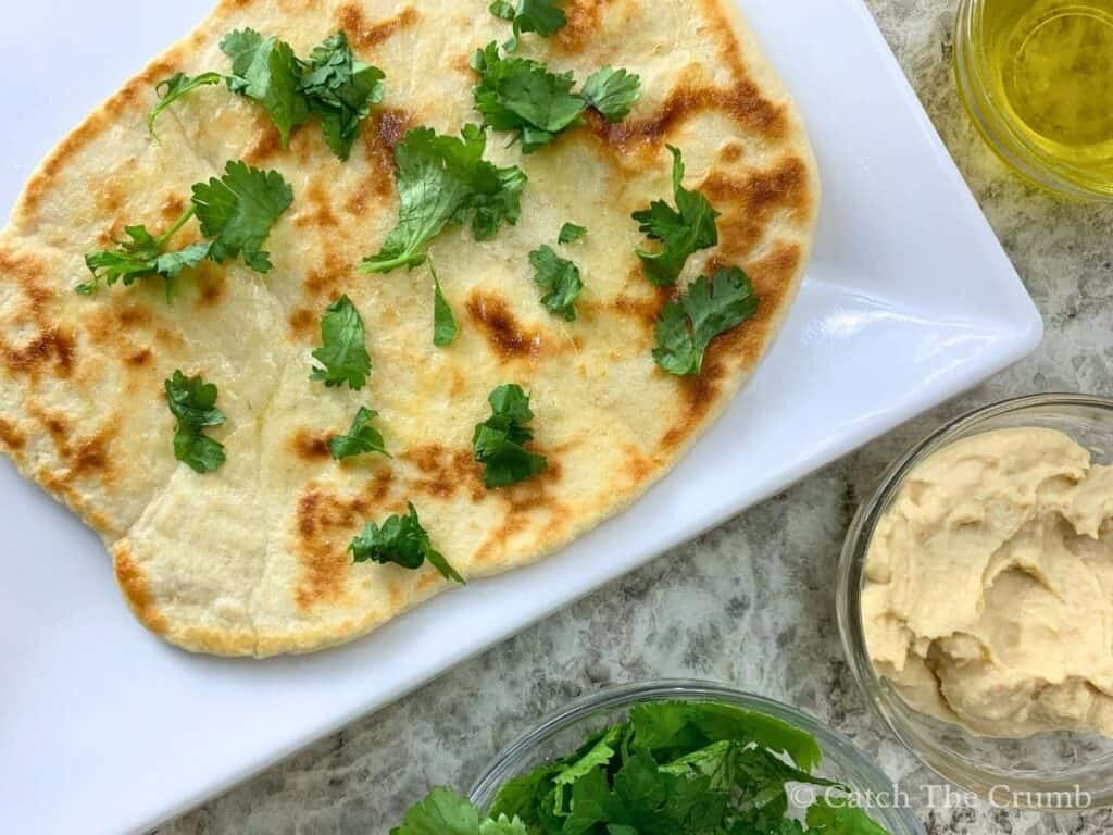 sourdough discard naan topped with diced cilantro