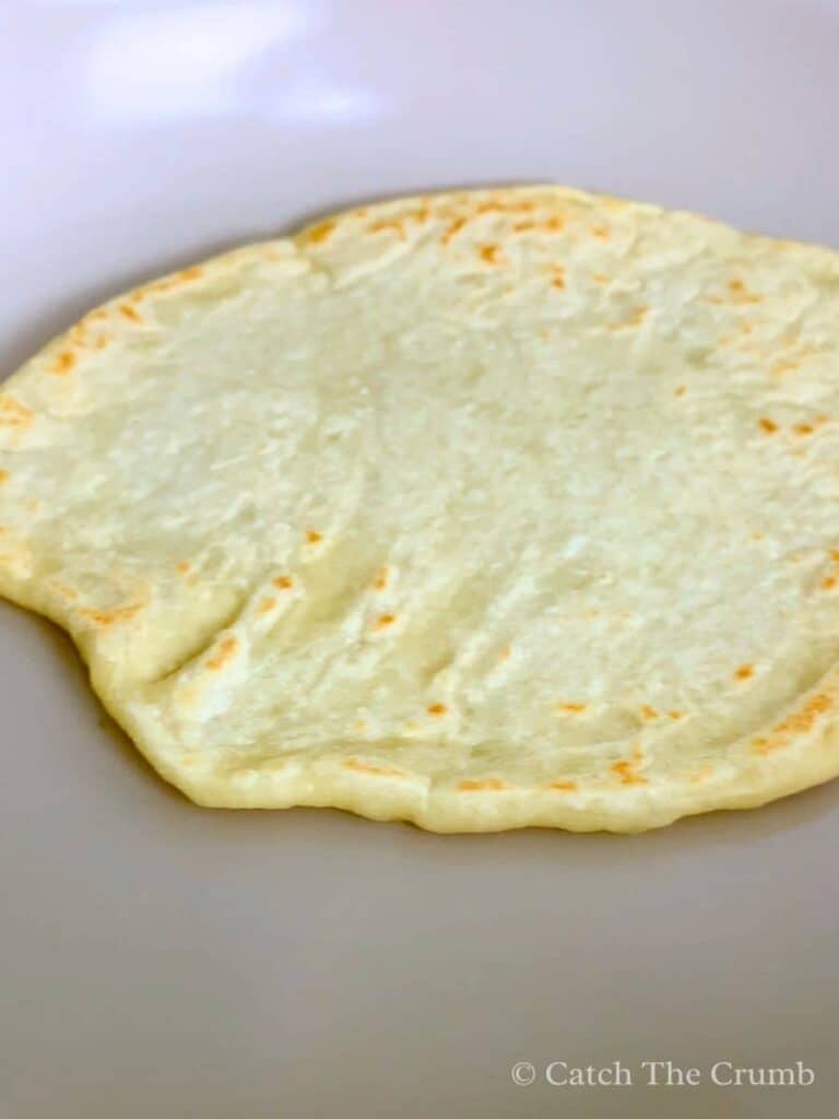 sourdough discard tortilla cooking in a skillet