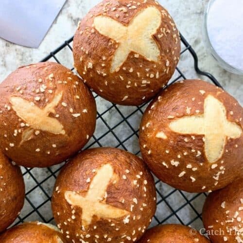 sourdough pretzel buns sitting on a cooling rack