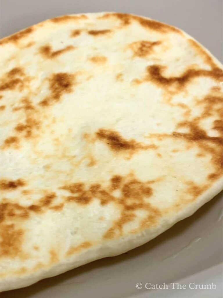 the naan flipped to cook on the other side